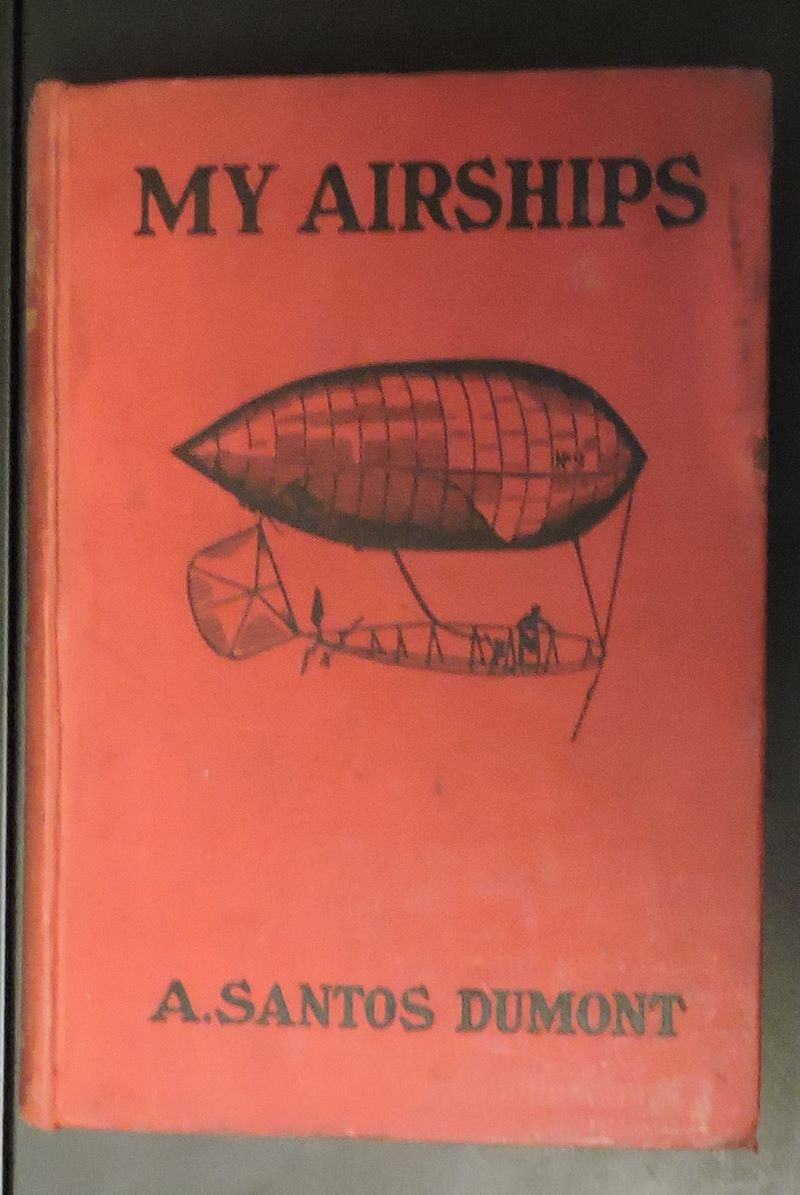 Picture of red cloth book cover showing black drawing of airship, title and author also in black.